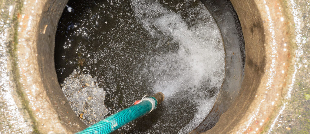 A photo of a water hose in a large drain